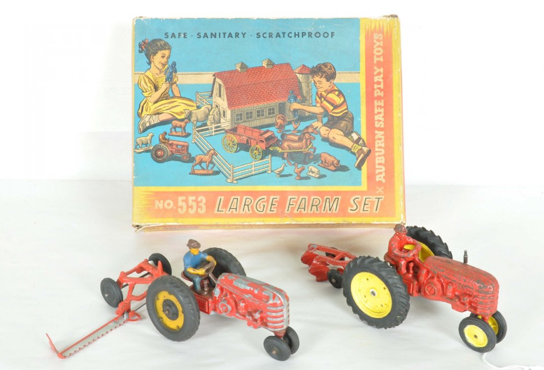 Farm Toy Lot: Includes a cast iron Hubley tractor with some over-painting; diecast Hubley tractor, C4; cast aluminum operating saw; cast plow; boxed Auburn Rubber farm playset. It appear complete minus the wagon tr
