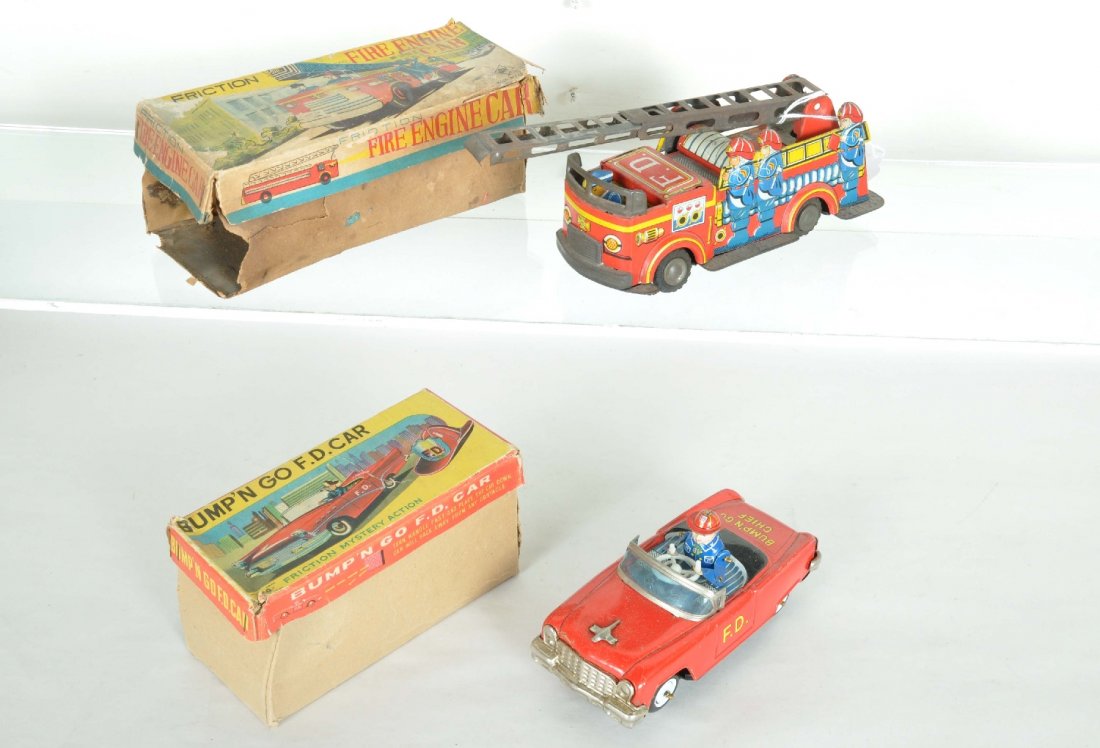 2 Boxed Tin Fire Department Vehicles: Includes a super 7" Fire Chief car, KO Japan, litho tin, crank operation with bump'n go action, worn ob, C7+; 7 1/2" fire ladder truck, litho tin friction, trim plating worn with extendable ladder, ro