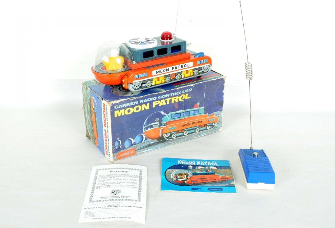 Boxed Gakken Moon Patrol: Clean tin litho tin space toy, 11" long with remote control. Mechanism didn't respond when tested, but toy appears like new with instructions and box, C8+-9