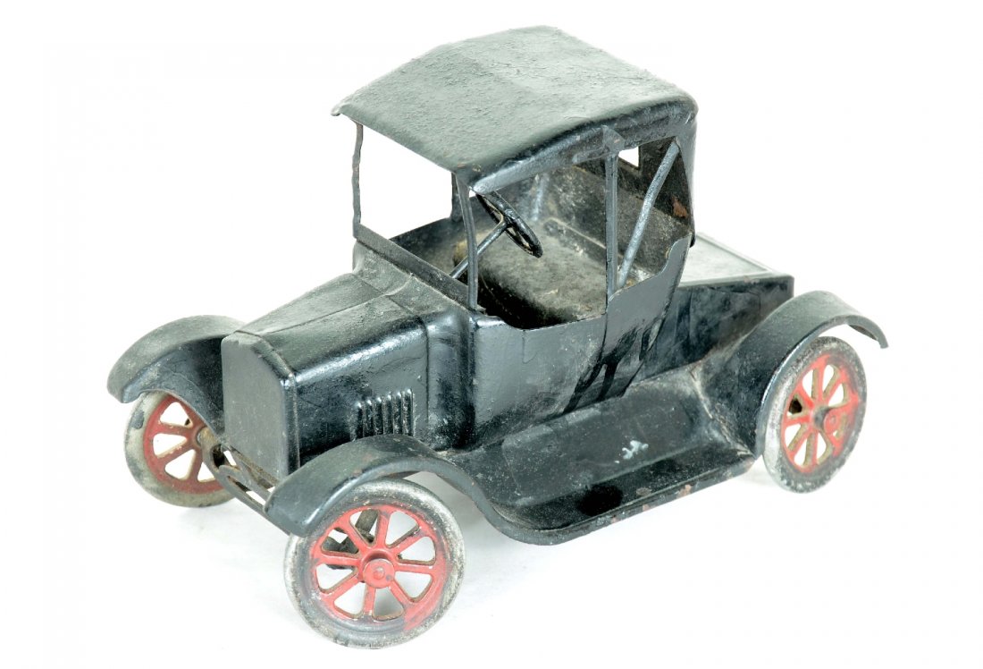 Buddy L Flyvver Coupe: Circa 1920s. Painted pressed steel, 10 1/2" long with steerable front wheels. This example is over-painted and the rear axel support is broken. Needs restoration