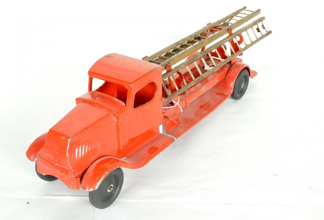 Turner Mack Fire Ladder Truck: Circa 1925. Painted pressed steel, 28" long, Bullnose Mack styling with original ladders. Manual lift raises center ladder and extensions clip on. Ladders show heavy paint wear, C3, truck shows only m