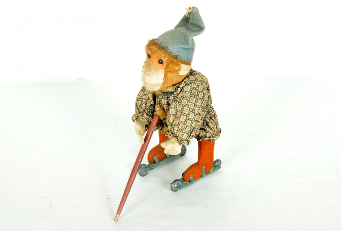 Scarce Bing Skating Monkey: Circa 1918. 9" tall, cloth and plush covered with wood cane. Mechanism is functional, but cane is missing its rubber tip. Place cane in front, it goes backward, place in back, goes forward, very ingen