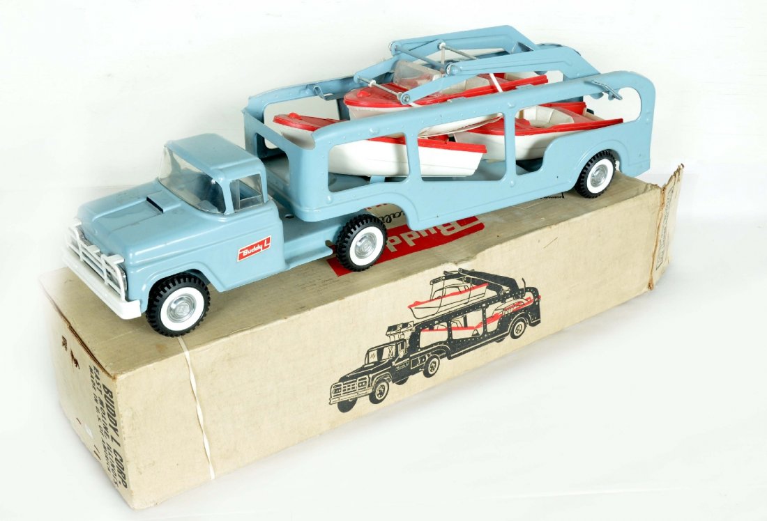 Boxed Buddy L Self Loading Boat Hauler: #5466. Nice example of this scarce truck. It is 26" long, painted and decaled pressed steel with rubber tired and plastic trim. It has its 3 original boats, though they are missing some parts. The lif