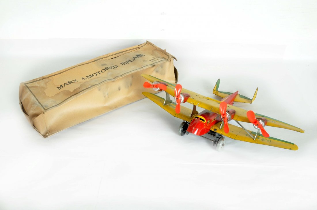 Boxed Marx TWA 4-Motor Bi Plane: Great toy with an 18" wing span. The mechanism functions and it has all its original celluloid props. It is fairly clean and straight with a worn, stained, but scarce original box, C7-7+
