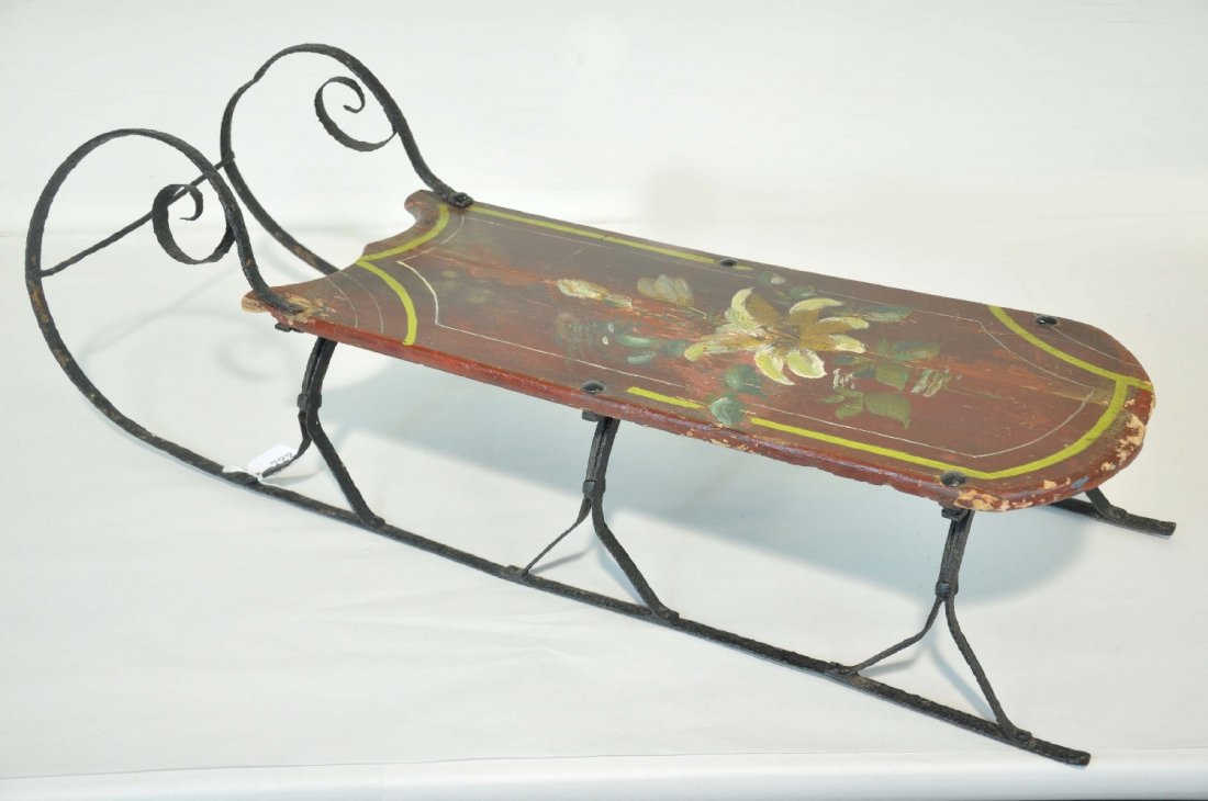 19th Century Childs Sleigh: 33" long, hand painted wooden seat with floral pattern, hand wrote iron blades and supports. Has some minor repair, but has a great folk art look