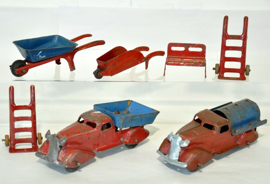 7Pc Marx Truck & Accessory Lot: Includes a 6" dump truck; 6" fuel truck, replaced grill; 2 wheel barrows; two hand trucks and a bench. All show moderate to heavy playwear, C4-5
