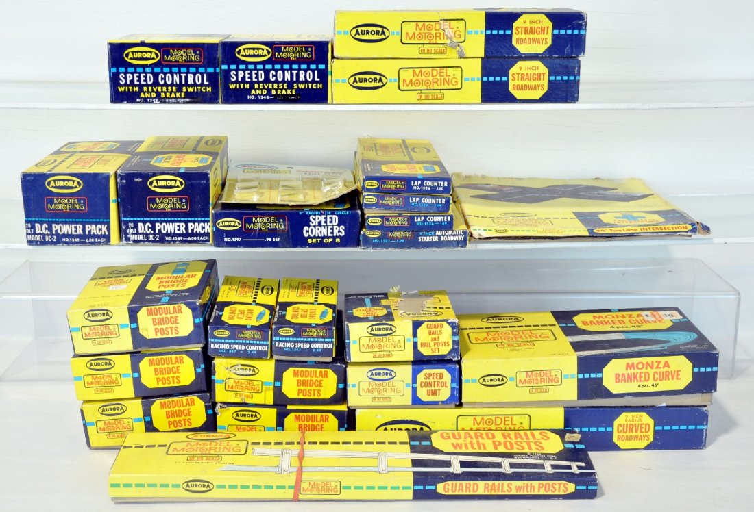 Boxed Aurora HO Slot Car Track & Accessories: Includes 1516 curves(5pc); 2 #1348 Speed controllers; 1526 Lap Counter; 1507 Starter Roadway; 1517 Straight Roadway; 1533 Speed Controller; 1532 Guardrail(partial); 1467 Banked Curve; 1532 Guardrail;