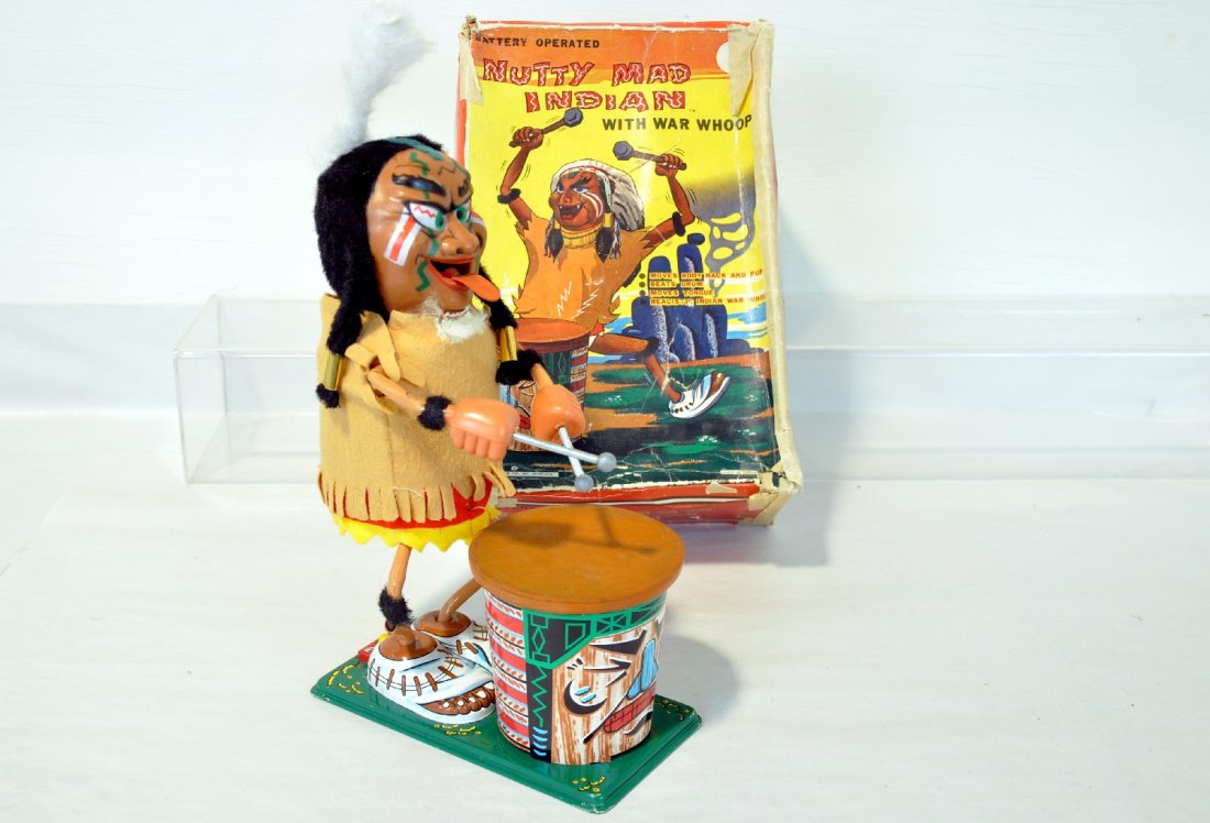Boxed Marx Nutty Mad Indian: 14" battery operated toy. Litho tin, plastic with rubber drum. The mechanism functions, but sound was soft (batteries were weak). It shows slight signs of use with a colorful, but worn box, C8+
