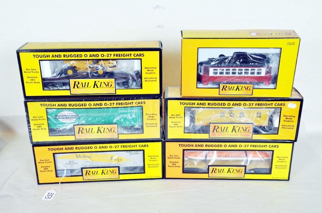 6pc MTH RailKing Group: Includes a 30-2557 Pittsburg bump-n'go trolley; 30-7414 NYC boxcar; 30-7709 C&O caboose; 30-7461 WP boxcar; 30-760901 flat with Sub; 30-7614 flat with dump truck. All have boxes. Perfect paint and tri
