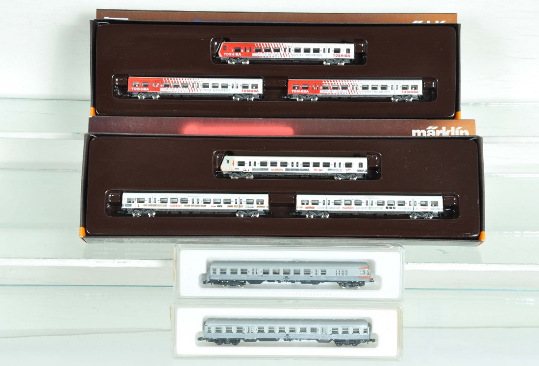 Assorted Marklin Z Gauge Passenger Cars: 8783 Toshiba 3-car set; 8779 Marklin 3-car set; 8716.2 & 8718.1 DB commuters. All appear like new with boxes, C9-10