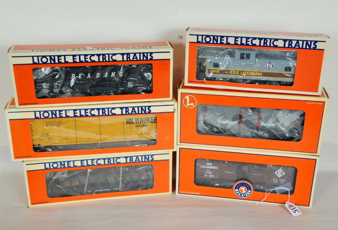 6 Lionel Freight Cars: Includes 26787 Erie Jumping Hobo car; 17510 NP log flat; 17223 MR boxcar; 19779 SP bay window caboose; 17111 Reading hopper; 16906 Erie extended vision caboose. All show very light runtime with C9 bod
