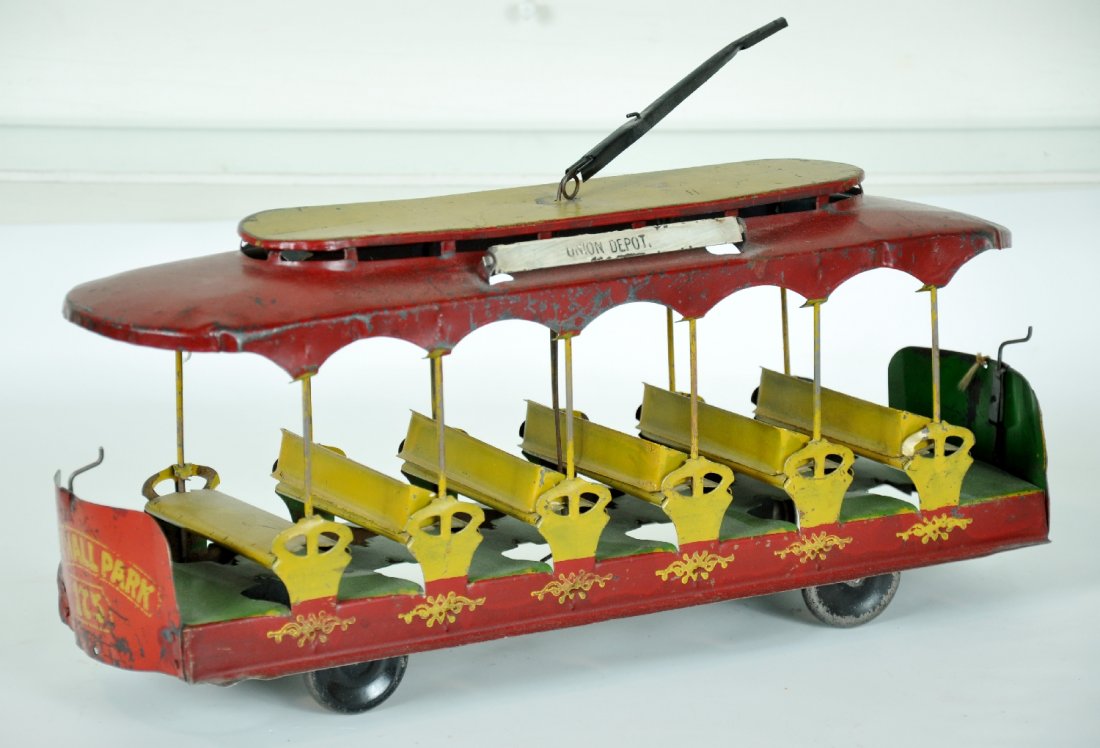 Nice Early Converse Trolley: Circa 1905. 16" hand painted pressed tin with stamped sign boards. This is the non-mechanical version and is in great original condition. It is just missing 1 seat back. The paint finish has a nice sa