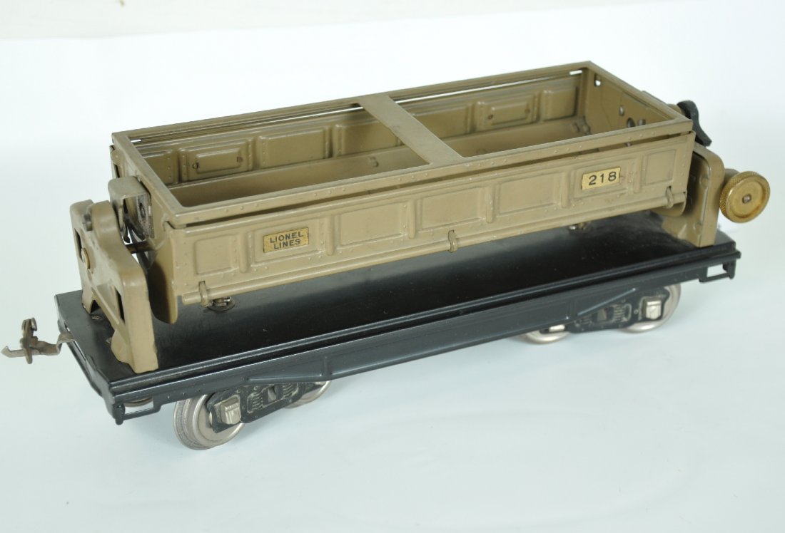 Nice Lionel 218 Dump Car: ST. Gauge. Clean with nice satin patina. Painted ends version. It shows almost no playwear, but the tipple gear is showing fatigue. Otherwise C8+ Nice example