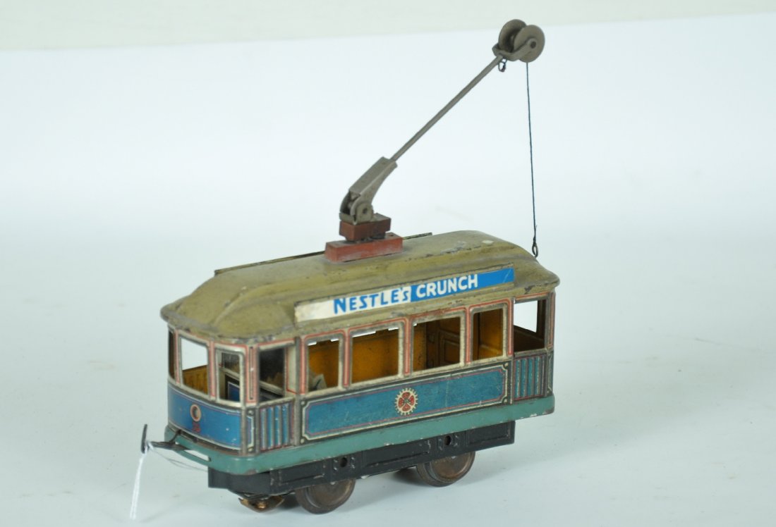 Carette Trolley: 1930s litho tin trolley with pole. 3-rail electric motor added and sign boards have been augmented as well. Otherwise shows moderate playwear, C5+-6
