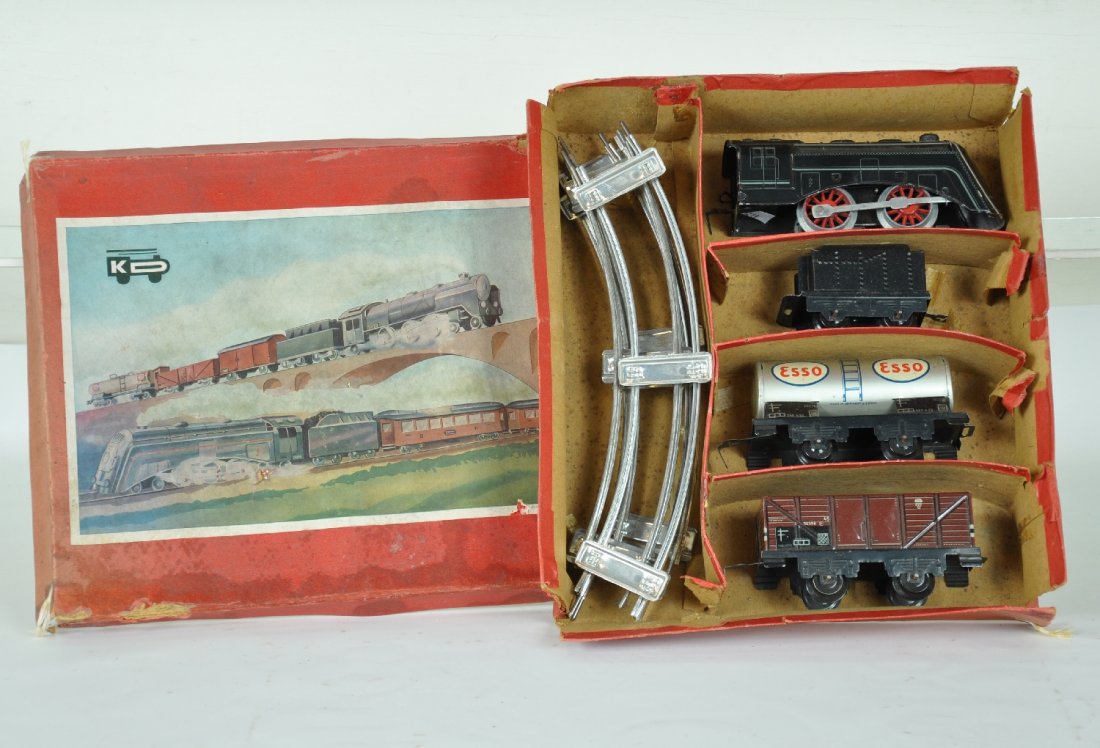 Boxed Karl Bub Train Set: Cute pre war set with an O ga. Streamline loco with functional mechanism; tender; Esso tank car & open goods wagon with track & worn set box. Trains show light to moderate playwear, C7-7+