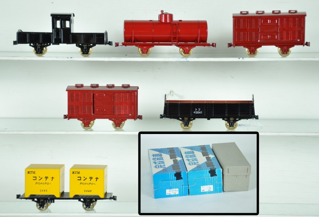 Unusual KTM Brass O Scale Freights: Japanese domestic production. Includes a factory painted boxed container flat; boxed tank car; boxed open car; 2 live stock cars & a transfer caboose(C7). Otherwise All appear like new with minor sign