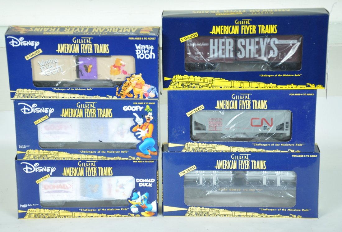 6 Lionel-American Flyer Cars, Disney: S Gauge. Disney cars include 48357 Winnie the Pooh; 48349 Goofy; 48351 Donald Duck; plus 48823 Hershey reefer; 48621 CN hopper; 48527 SF jet engine flat. All appear to be new in box, C10