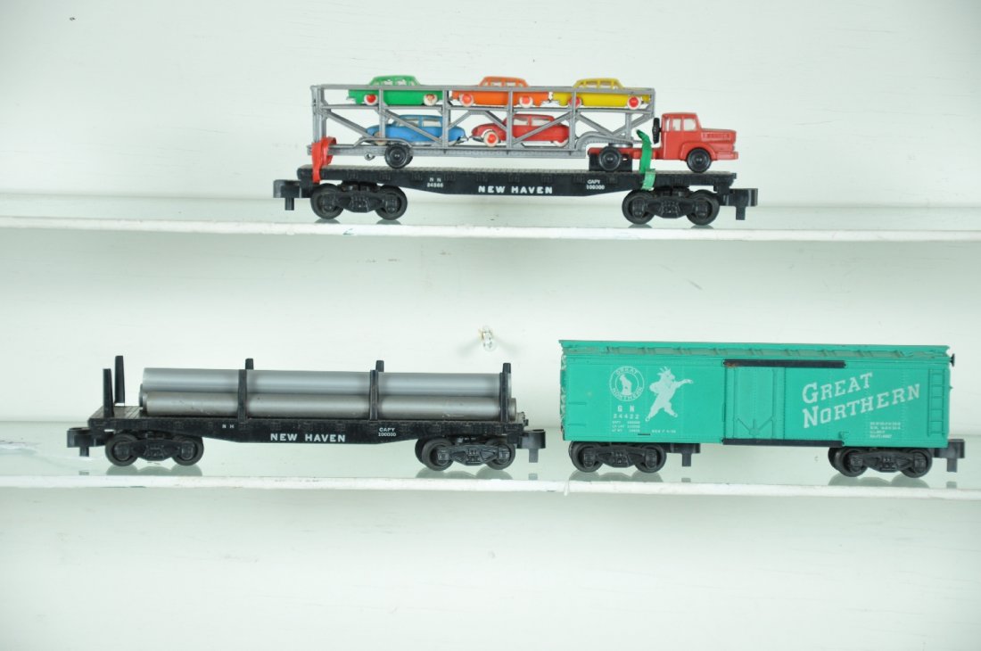 3 Nice American Flyer Freight Cars: S Gauge. Includes a 24566 NH flat with Norev auto-loader; scarce 24422 GN reefer with sliding doors; un-numbered (24537) flat with pipes. All show light playwear, C7+-8