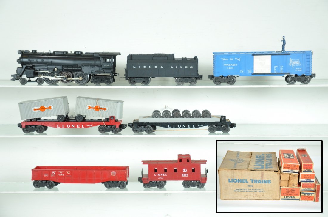 Boxed Lionel Set 1561WS: Circa 1956. Includes a 2065 steam loco, great patina; matching 6026W tender; 3424 brakeman car with packet; 6430 flat with Cooper-Jarrett vans; 6562-25 gondola, missing canisters; 6262 wheels car; 625