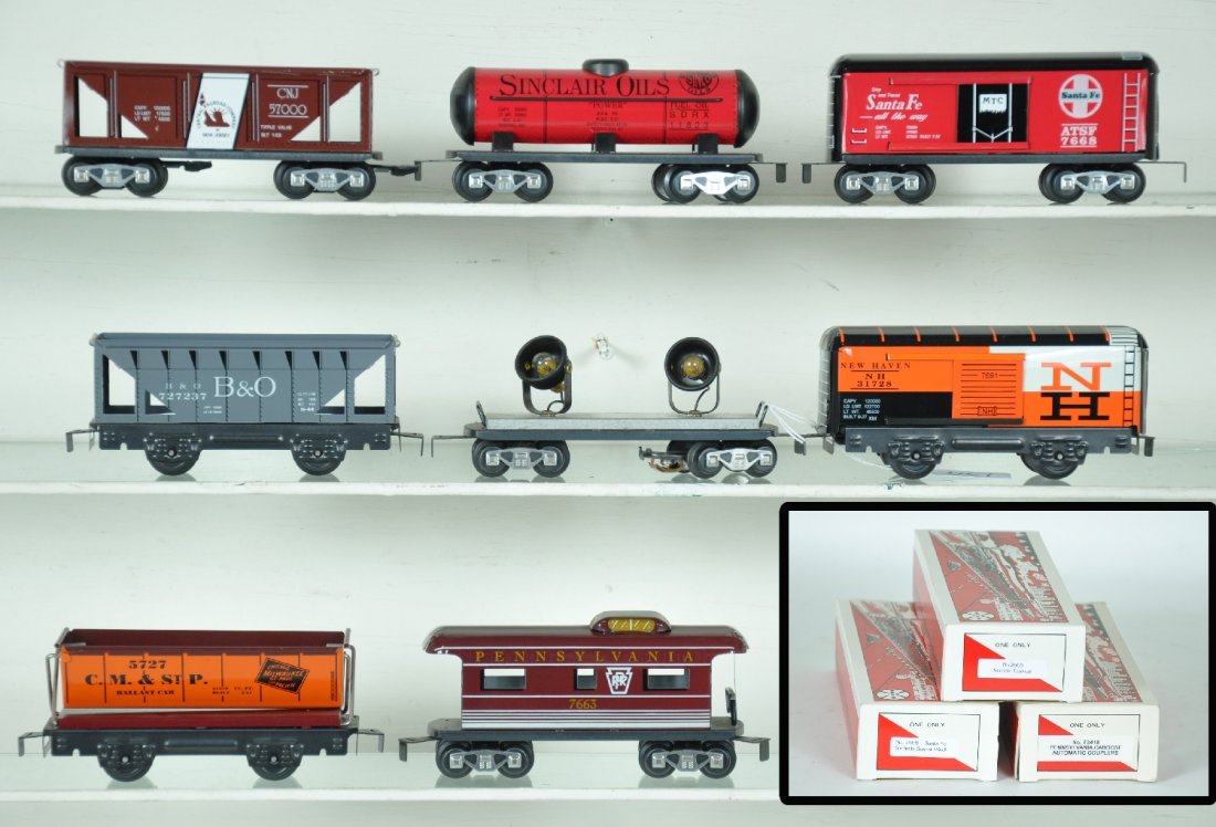8 Modern Marx Freight Cars, 3 Boxed: Includes a Boxed 7341B PRR caboose; boxed 7668 SF boxcar; boxed 7665 Sinclair tank car; double searchlight, CNJ hopper, CM&StP tipple, NH boxcar & B&O hopper. All show signs of display, C8-9