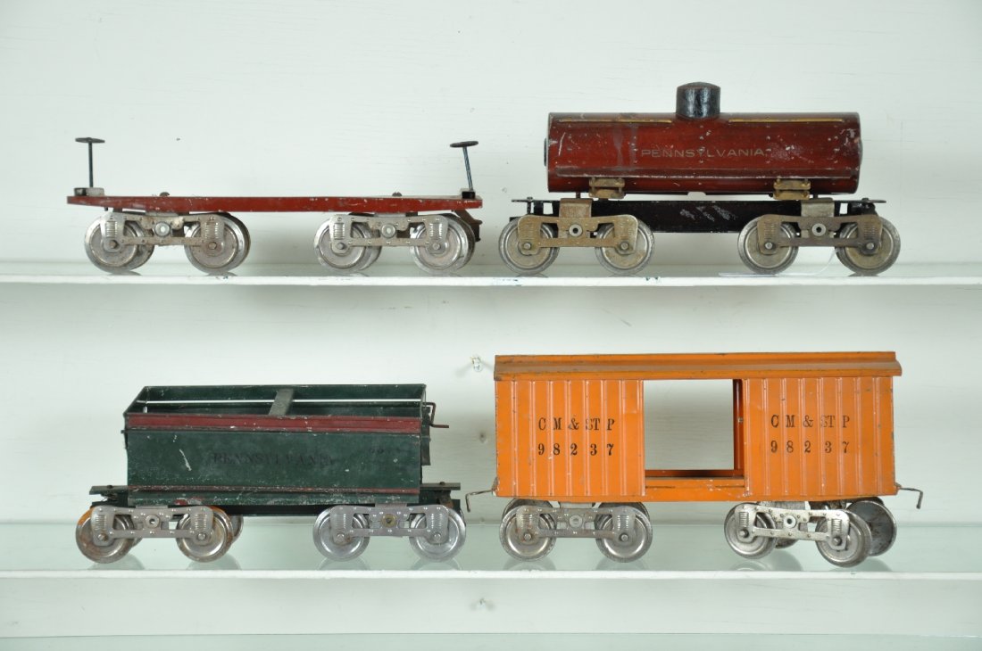 4 Lionel 10 Series Freight Cars: ST, Gauge. Includes a 16 PRR dump car; 11 flat car; 14 boxcar & 15 PRR tank car. All Corporation variations. They are fairly clean & shiny, showing moderate playwear, C5-6