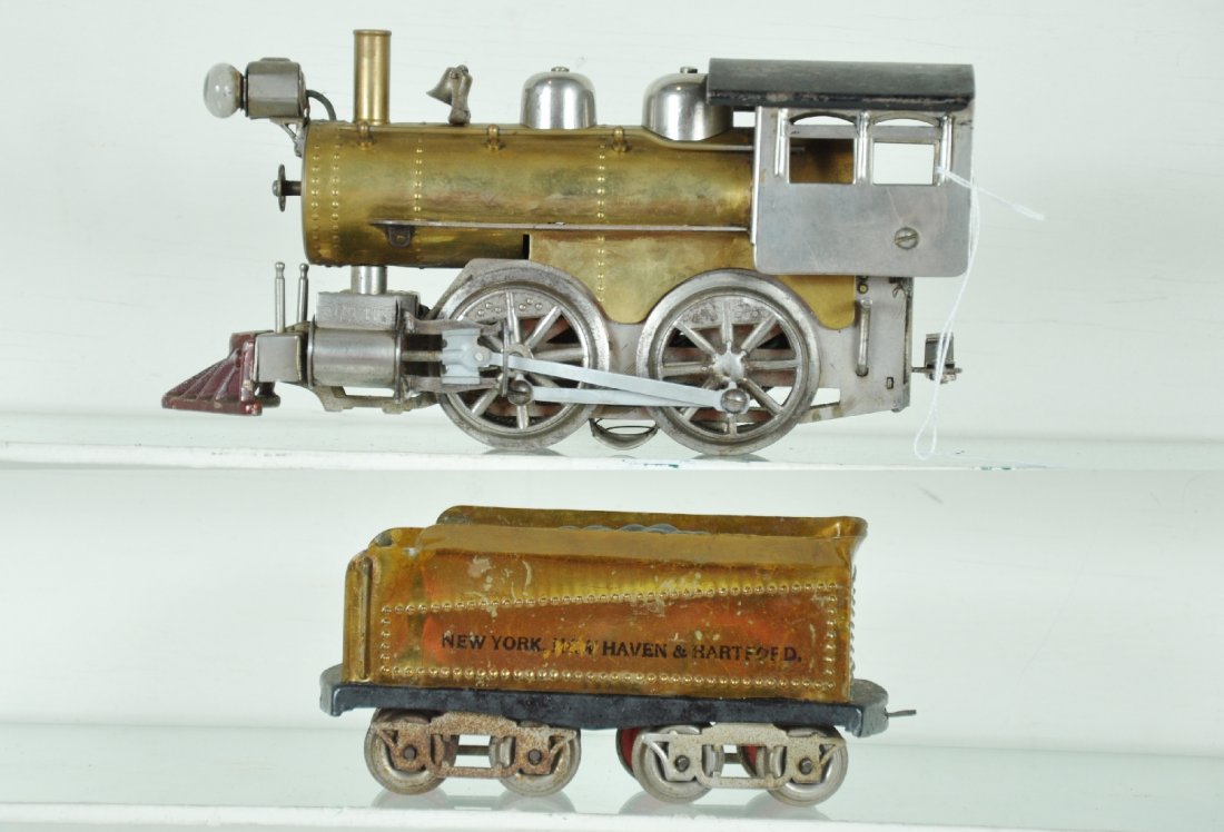 Clean Elektoy Steam Locomotive: Circa 1912. Gauge 2. Nice and clean brass & nickel loco. Matching re-lettered NYNH&H tender. Clean, showing light to moderate playwear, C6+ Otherwise nice example