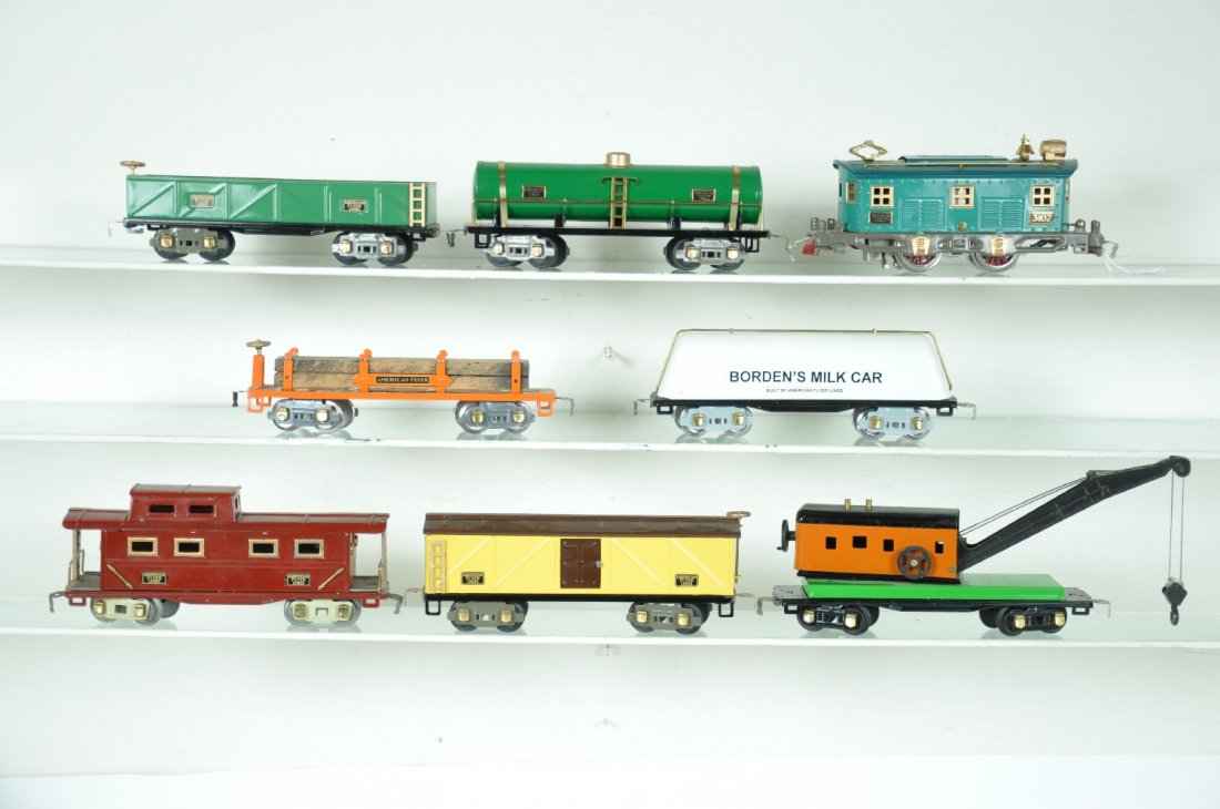 8Pc Restored American Flyer Freight Set: Includes a 3107 boxcab electric; 3207 sand car; 3210 tank car; modified 3212 wrecker; 3225 Borden's Milk car; 3208 boxcar; 3206 machinery car with load; 3211 caboose. All beautifully restored to appea