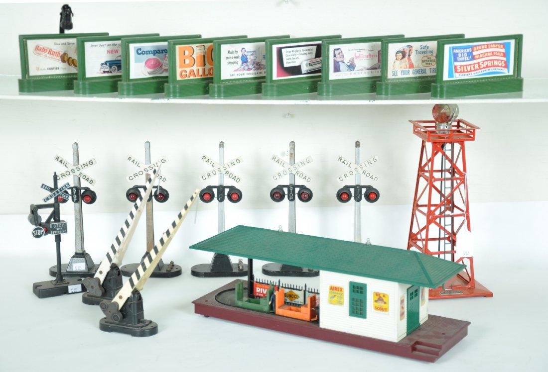 Lionel Accessory Lot: Includes a 356 operating freight station with carts; loose 310 billboard set; 5 #154 flashers; 2 #252 crossing gates, 1 missing red lens; 140 banjo signal; 494 beacon, some sun fading. Otherwise all s
