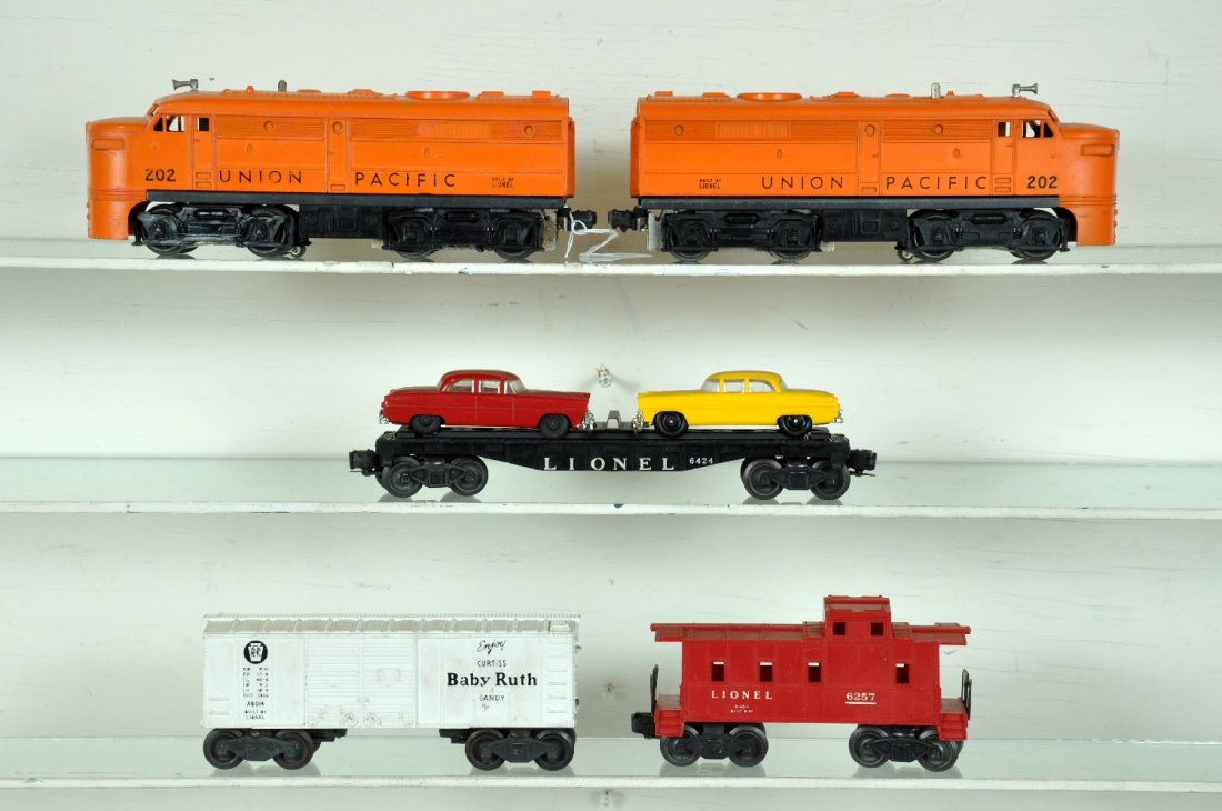 5Pc Lionel 202 Diesel Freight Set: Includes 2 #202 UP Alco A Diesels, 1 shell is touched-up, C6; 6424 auto-loader, yellow car is replaced; x6014 BR boxcar; 6257 caboose, stress mark at roof corner. Otherwise shows light playwear, C7-8