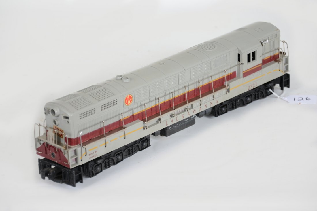 Lionel 2321 Gray Top Lackawanna Diesel: Nice dual motor FM. It has a few minor oxidation spots on the handrails with usual hairline screw cracks. The battery box is clean, but has a 2" hairline crack near stacks on roof. It shows light play