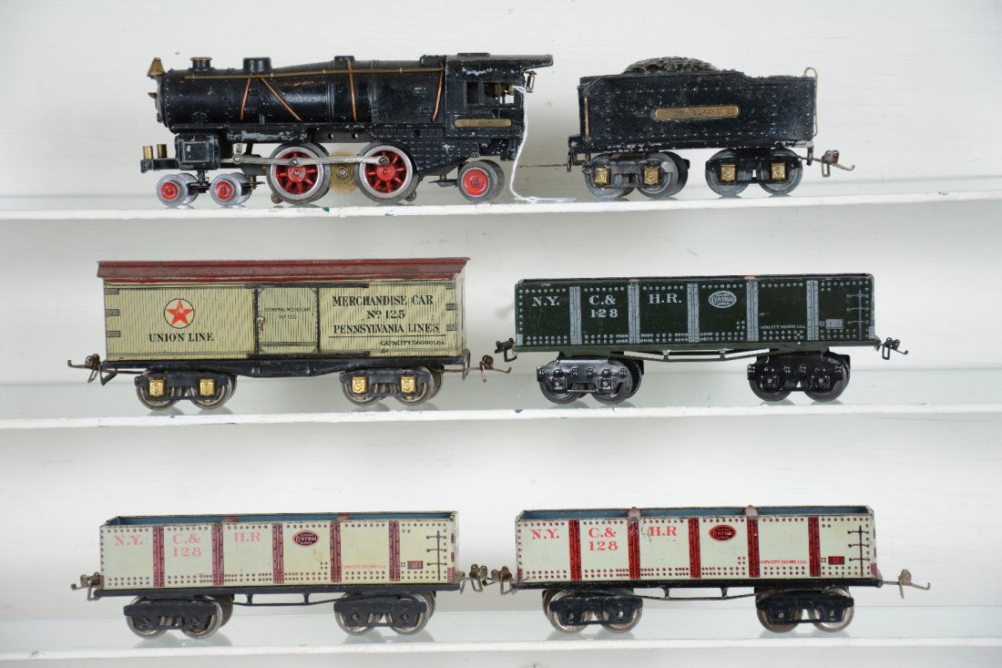 6Pc Ives 1122 Train Set: Includes an Ives 1122 steam loco, replaced wheels & rods body casting has issues; 1122T tender, light warpage; 3 #128 gondolas; 125 Union boxcar. Cars show moderate playwear, C6