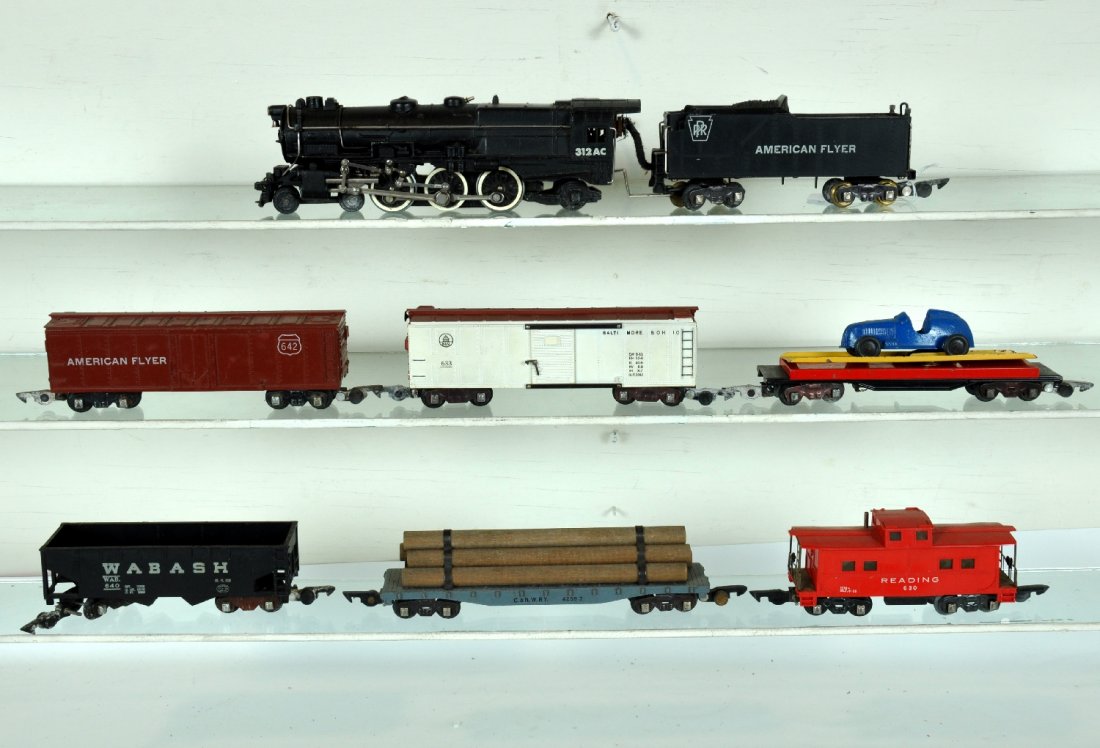 7Pc American Flyer 312AC Freight Set: S Gauge. Includes a 312AC PRR K-4 loco; 642 reefer; 640 Wabash hopper; 715 unloading car with TootsieToy racer; 638 log flat; 633 B&O boxcar; 630 Reading caboose. All are clean, showing light to moder