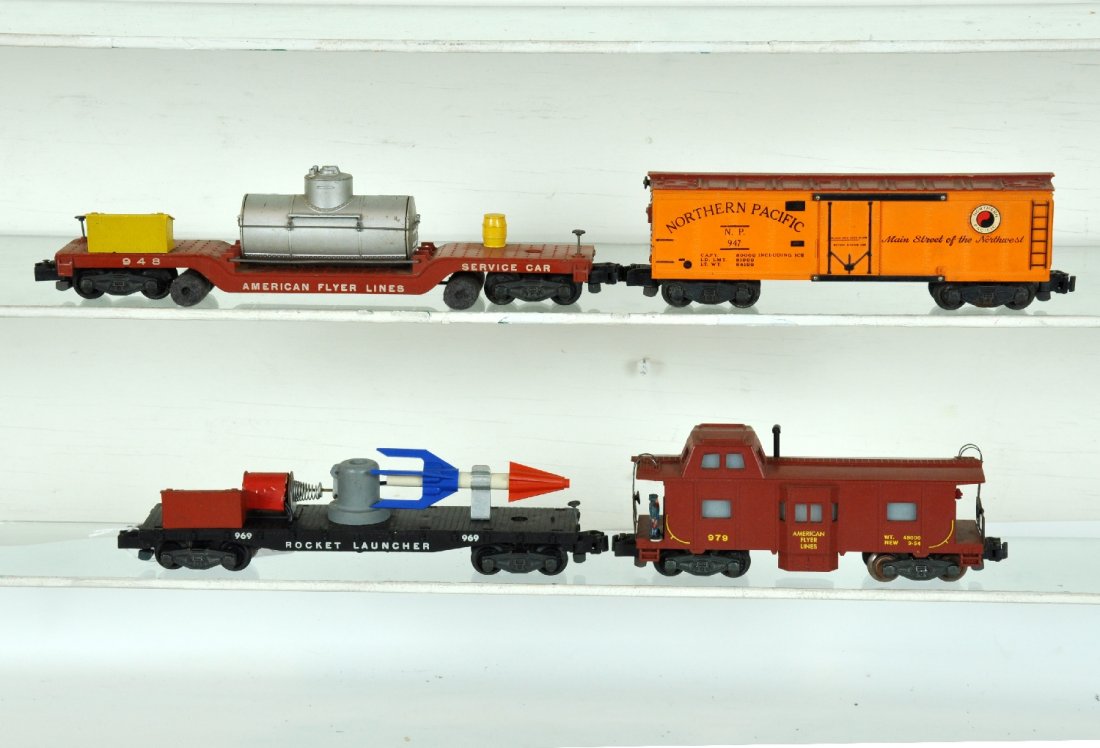 4 Clean American Flyer Freight Cars: S Gauge. Includes a 669 rocket launcher; 947 NP reefer; 979 action caboose, missing 1 step; 948 track cleaner, otherwise rest show light playwear, C7+-8