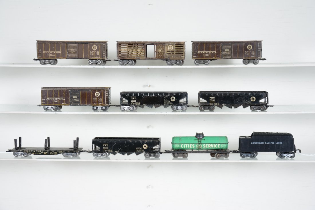 10 Marx 3/16 Freight Cars: Includes scarce PRR stock car,2 body tabs off,C5; 3 LNE hoppers; 3 PRR boxcars; CS tank car; SP tender. Rest show light to moderate playwear, C6-7