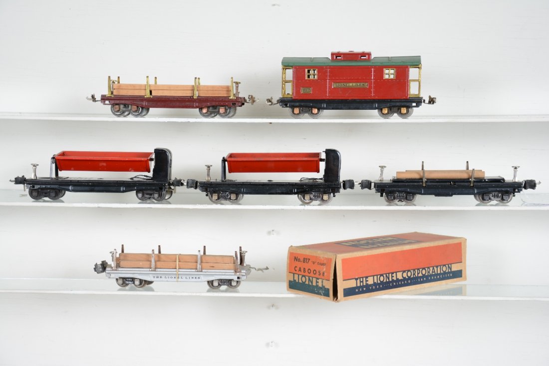 6 Pre War Lionel Freight Cars: Includes a boxed 817 caboose; 811 lumber car, 1 stake loose, replaced load, C6; 2 #3859 coal dump cars, 1 41 HBC; 811 late lumber, 1 coupler upside down, missing 1 coupler box, but bright silver; 3811