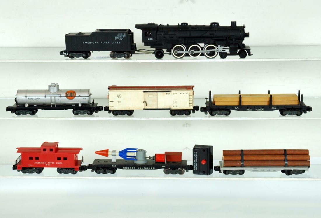 7Pc American Flyer 283 Steam Freight Set: S Gauge. Includes a 283 C&NW Pacific loco; 933 B&O boxcar; 925 Gulf Tank Car; 969 rocket launcher with controller; 905 log car; 928 NH flat with lumber load; 806 caboose. All are clean, showing light 