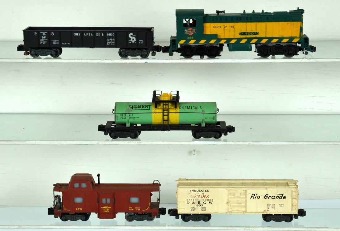 5Pc American Flyer 355 C&NW Diesel Set: S Gauge. Includes a 355 C&NW Baldwin diesel, steps intact with screw crack; 910 Gilberts tank car, touched-up; 911 C&O empty gondola; 807 Cookie Boxcar, lettering worn; Nice 979 action caboose, C8; ot