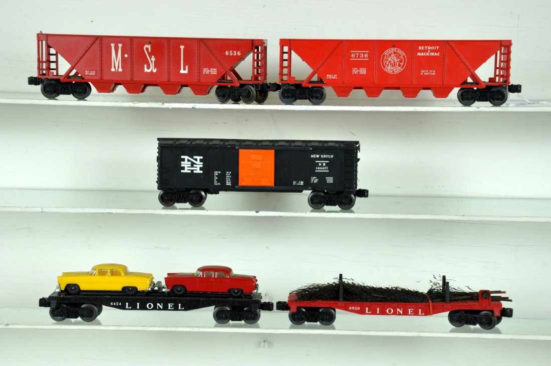 5 Clean Lionel Freight Cars: Includes a 6826 flat with original Christmas trees, bushier than normal!; 6736 D&M quad hopper; 6464-425 NH boxcar, type III; 6536 M&StL quad hopper, oxi spots on couplers; 6424-60 auto-loader. All ar