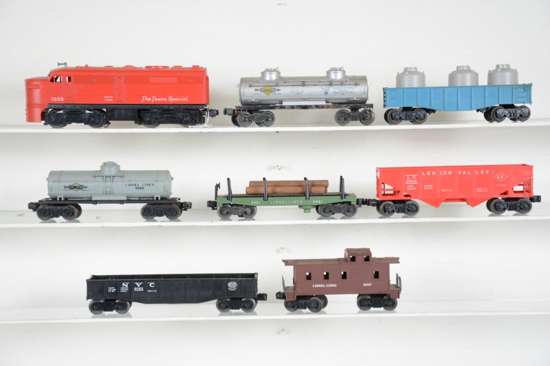 8Pc Lionel 1055 Diesel Freight Set: Includes a 1055 Texas special Alco A diesel; 3461-25 lumber car, oxi spots on platform; 6465 tank car; 6035 Sunoco tank; (6047) gondola; 6062 gondola; 2464 tank, missing one coupler assembly; 6017 cab