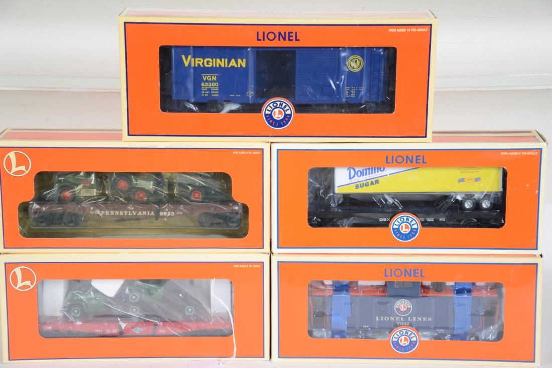 5 Lionel O Scale Freight Cars: Includes 17534 Domino flat with Macks; 17518 PRR flat with Macks; 17962 Lionel CA-4 caboose; 27265 DSX flat with trailer; 27265 Virginian PS1 boxcar. All appear unrun with boxes, C10