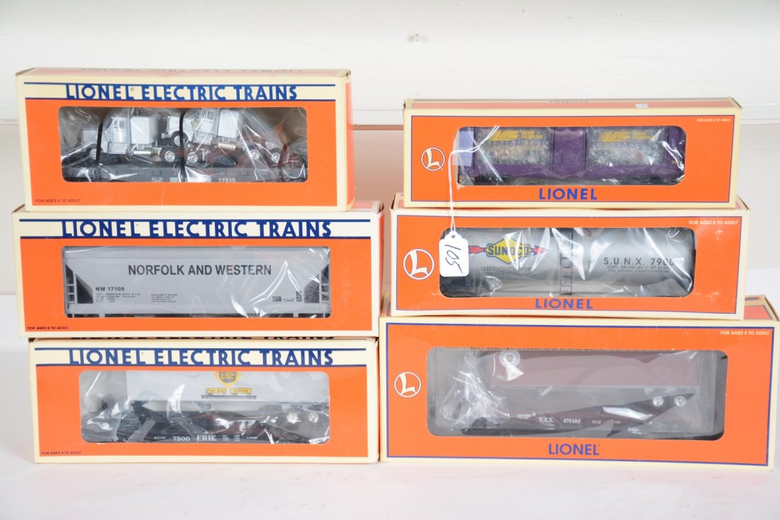 6 Boxed Lionel Freight Cars: Includes 17910 Sunoco unibody tank; 17109 N&W center flow hopper; 26951 PRR flat with trailers; 17515 NS flat with tractors; 19415 Erie flat with trailer; 16757 Johnny Lightning display boxcar. All ap