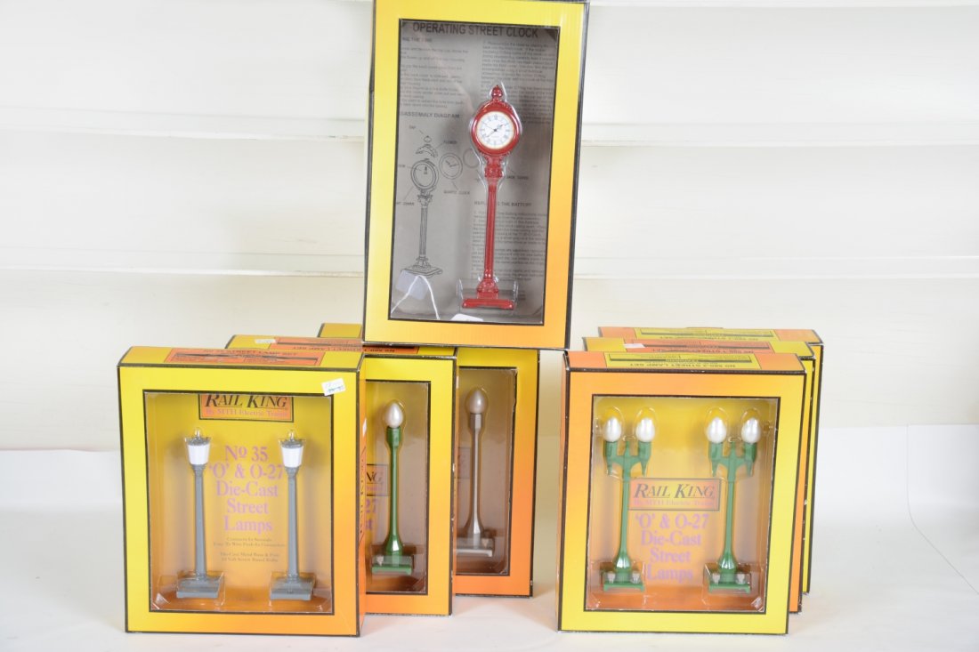 7 Boxed MTH RailKing Accessories: Includes 30-1061 operating clock; 3 #30-1079 lampposts; 30-1078 lamppost; 2 #1058 street lamps. All show light use with boxes, C8+-9