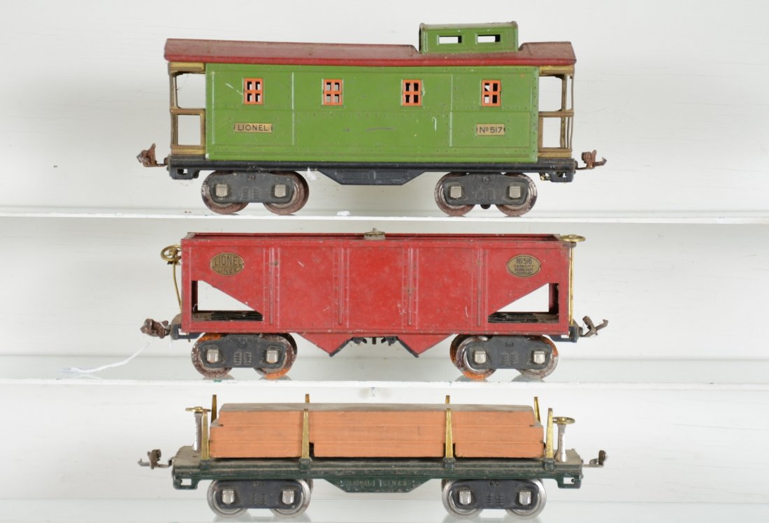 3 Lionel 511, 516, 517 Freight Cars: Standard gauge. Includes a 516 hopper, loose brake wheel, wheels have rust spots; 511 lumber; 517 caboose. All are dirty, but only show moderate playwear. Might clean to C6