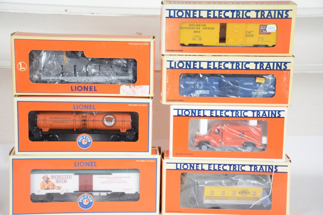 7Pc Boxed Lionel Group: Includes a 18432 motorized step van; 16243 Conrail boxcar; 19430 flat with airplane; 52448 Oilzum tank; 17617 D&RGW caboose; 52484 Bay State NETCA Beer car; 19823 Burlington ice car. All show light ru
