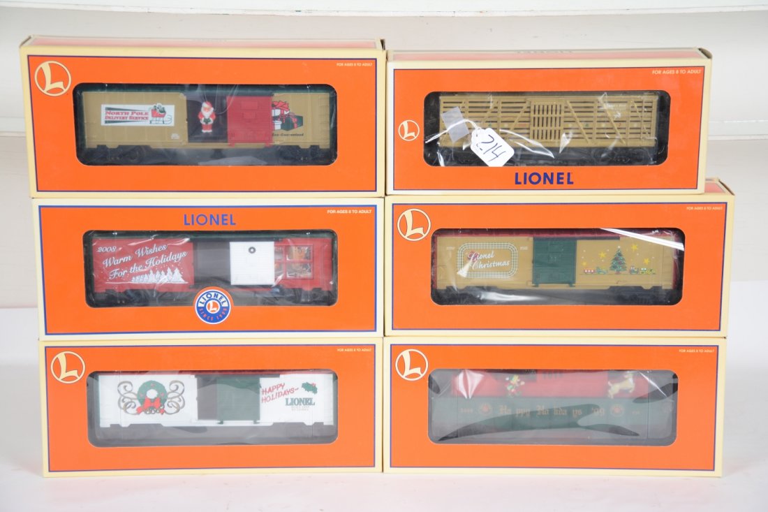 6 Lionel Christmas Cars, 1 Employee: Includes 26741 Santa operating boxcar; 26706 boxcar with lights; 25061 32008 boxcar; 19976 Employee boxcar #1999; 18795 Elf & Rudolf animated gondola; 26740 Reindeer car. All are mint with boxes, C10