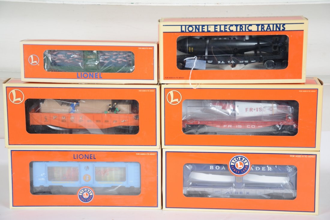 6 Lionel Freight Cars: Includes 16742 aquarium car; 26972 operating Pony Express gondola; 36780 Sea-Monkeys aquarium; 16677 flat with Navy sub; 36089 flat with airplane; 29413 Airex boat-loader. All are mint in box, C10