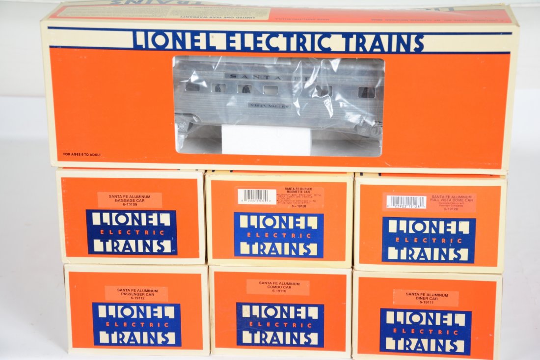 7 Lionel SF Aluminum Passenger Cars: Shiny cars to match the locos in lot 338. Includes 19109 baggage; 19110 combine; 19111 diner; 19128 full vista-dome; 19138 roomette; 19113 observation. All show light runtime with light mildew spots. 