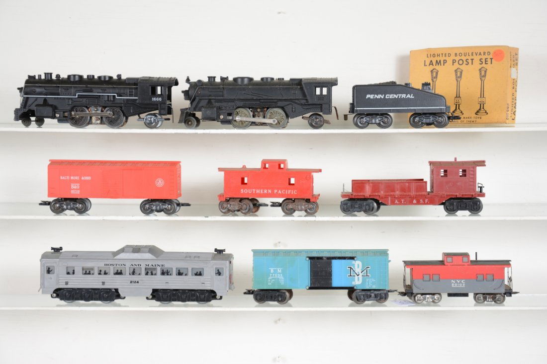 10Pc Marx Lot: Includes a 2124 Budd diesel, chip on front cowl, window material breached; 666 cast steam loco; PC slant tender; 1666 steam loco; 4 Freight cars; boxed 073/3 boulevard lamps. Some are dusty, all show
