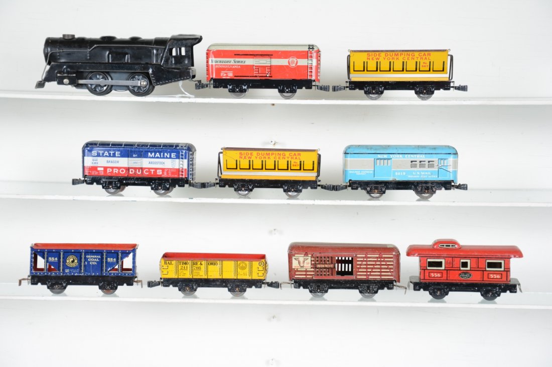 10Pc Marx Tin Group: Includes a tin wind-up loco with functional mechanism & bell; 5019 baggage Plus 8 additional tin Freight cars, all with intact knuckle couplers. They are clean, showing light to moderate playwear, C6+