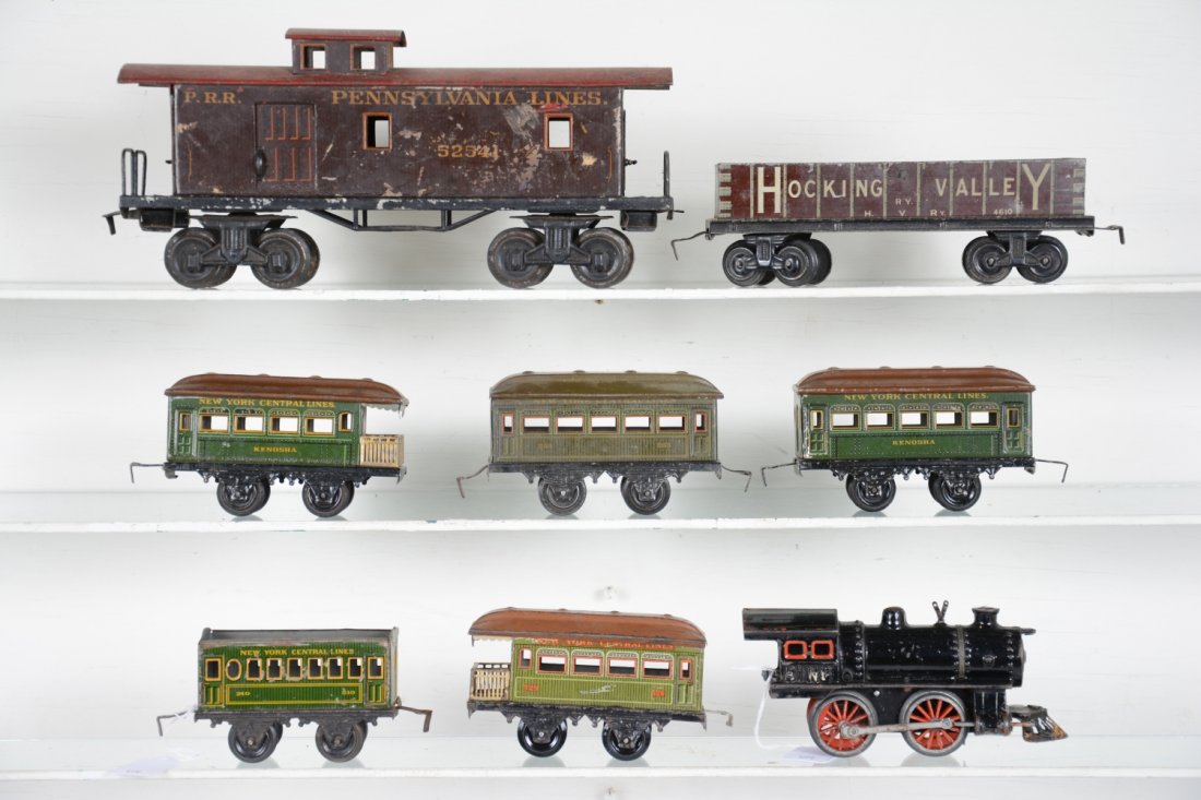 Bing Train Lot: Includes a PRR Gauge 1 caboose with repainted roof; Hocking Valley gondola; electric steam loco, front cow catcher is incomplete; 4 assorted passenger cars, 1 missing roof. Grade range is C4-6, so exa